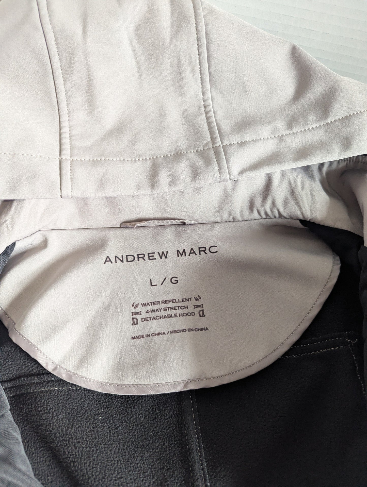 Close-up detail of the premium taupe 4-way stretch water-repellent polyester blend fabric on the Andrew Marc jacket.
