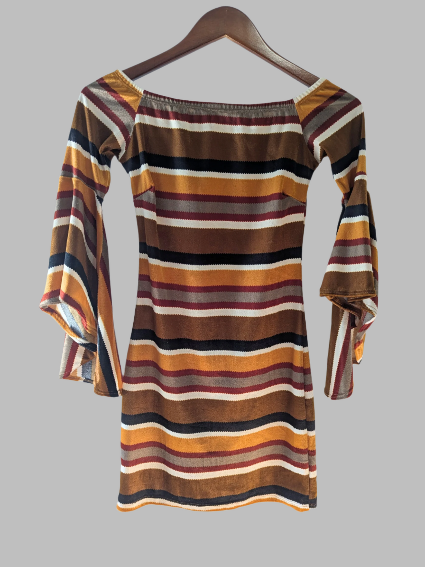 Back view of the striped Diosa mini dress showing the continuous pattern design and pencil style fit.