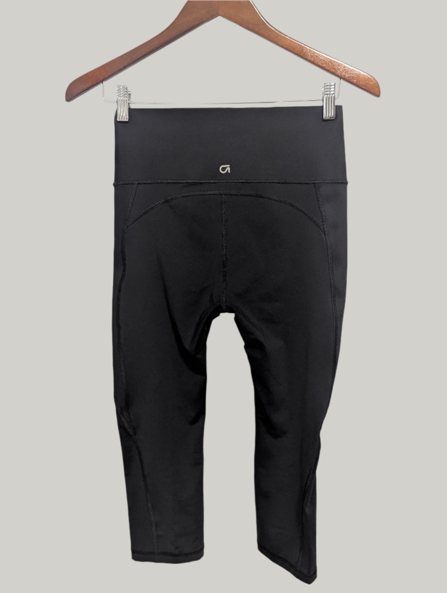 Back view of the black Gap Fit compression cropped leggings showing the clean athletic seams