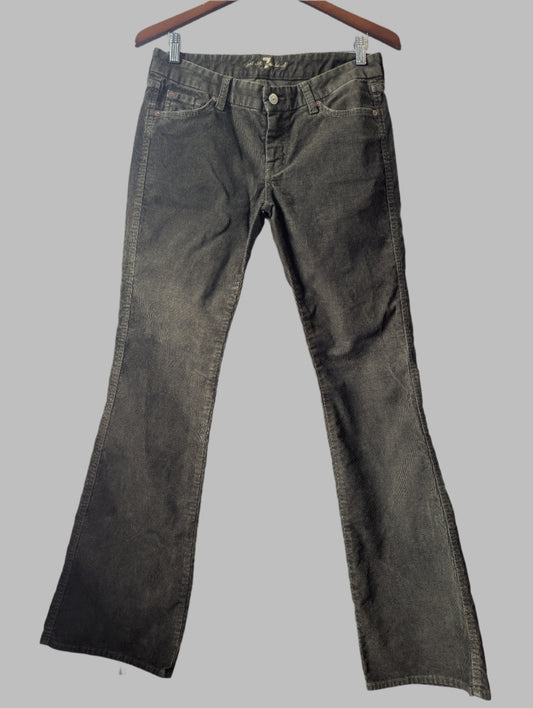 Front view of women's 7 For All Mankind khaki green bootcut corduroy pants hanging up.