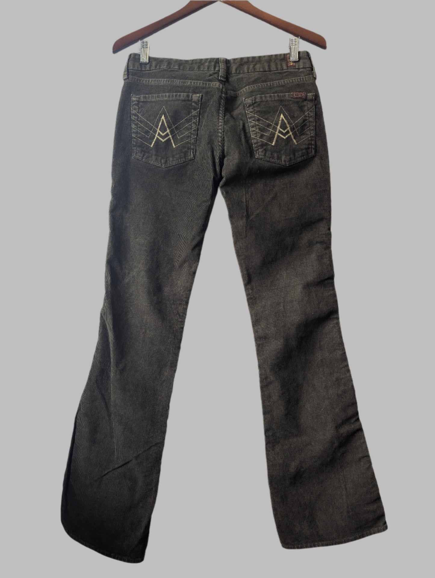 Back view of the 7 For All Mankind green corduroy bootcut pants highlighting the classic rear pocket design boho
