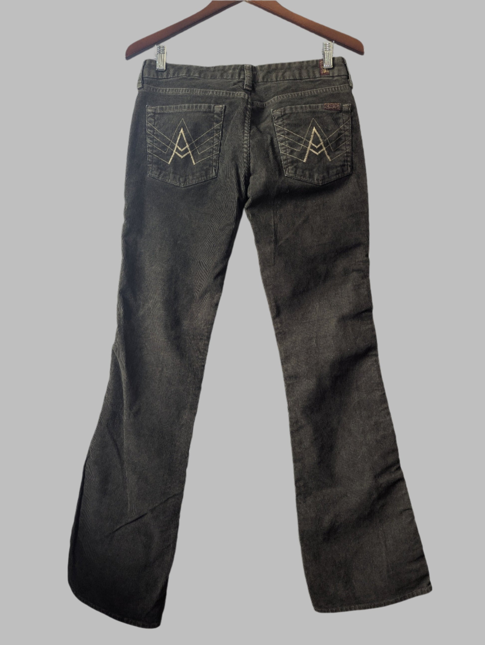 Back view of the 7 For All Mankind green corduroy bootcut pants highlighting the classic rear pocket design boho