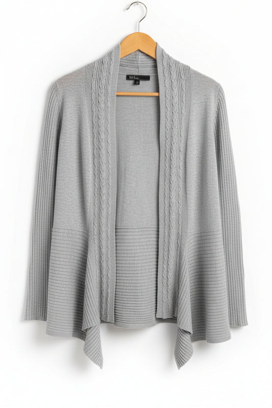 Front view of a grey ribbed 89th & Madison open front cardigan with a shark bite hem hanging on a hanger.