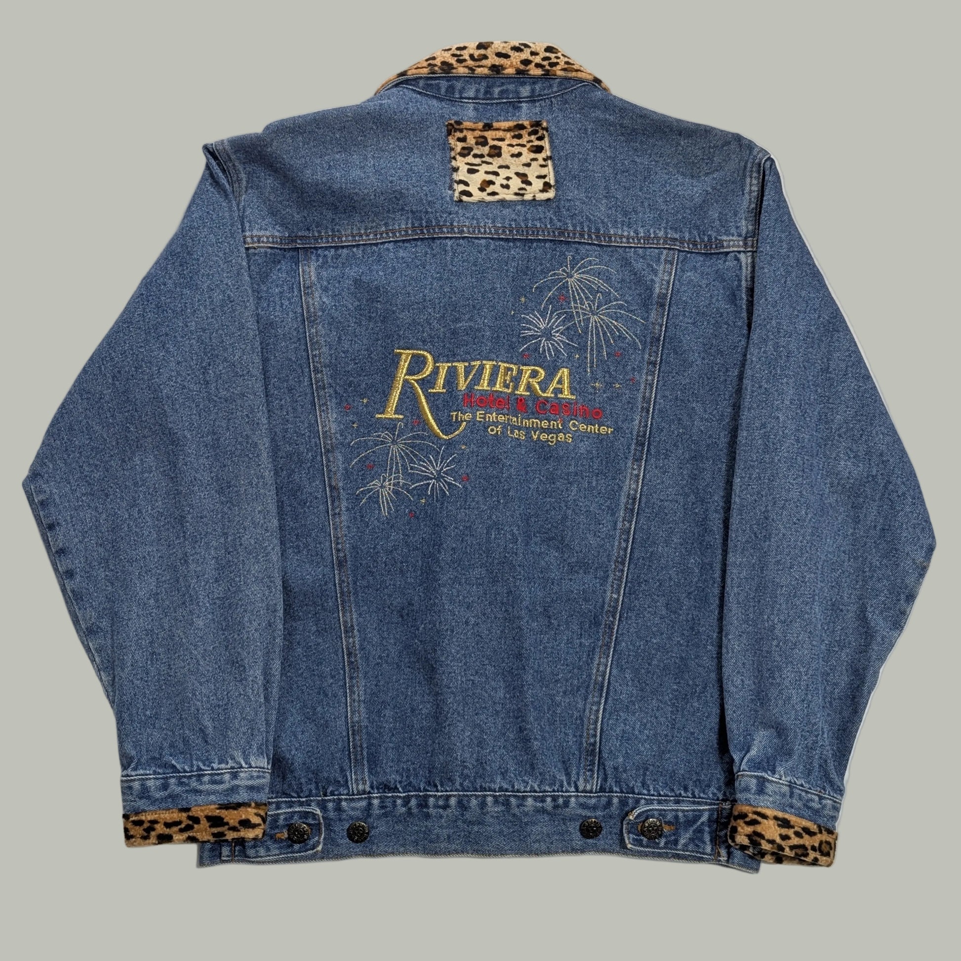Full back view of the vintage Riviera Hotel Las Vegas denim jacket, showcasing the large custom embroidered logo across the shoulders for a retro Americana look.