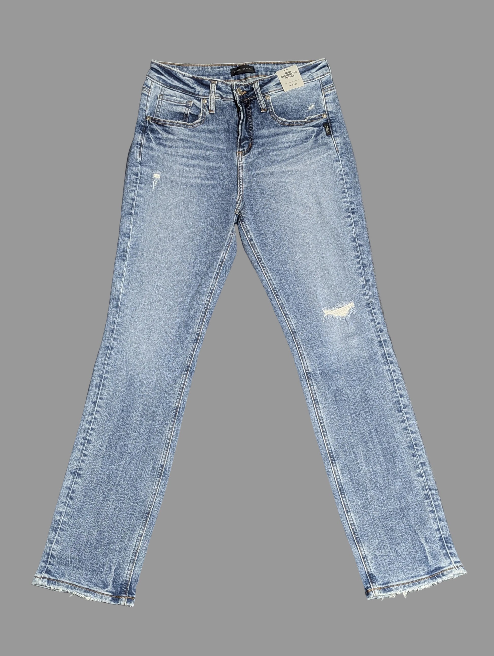 Front view of Silver Jeans "Beau" girlfriend fit mid-rise denim jeans in a medium wash with distressed details, highlighting a vintage thrift aesthetic.