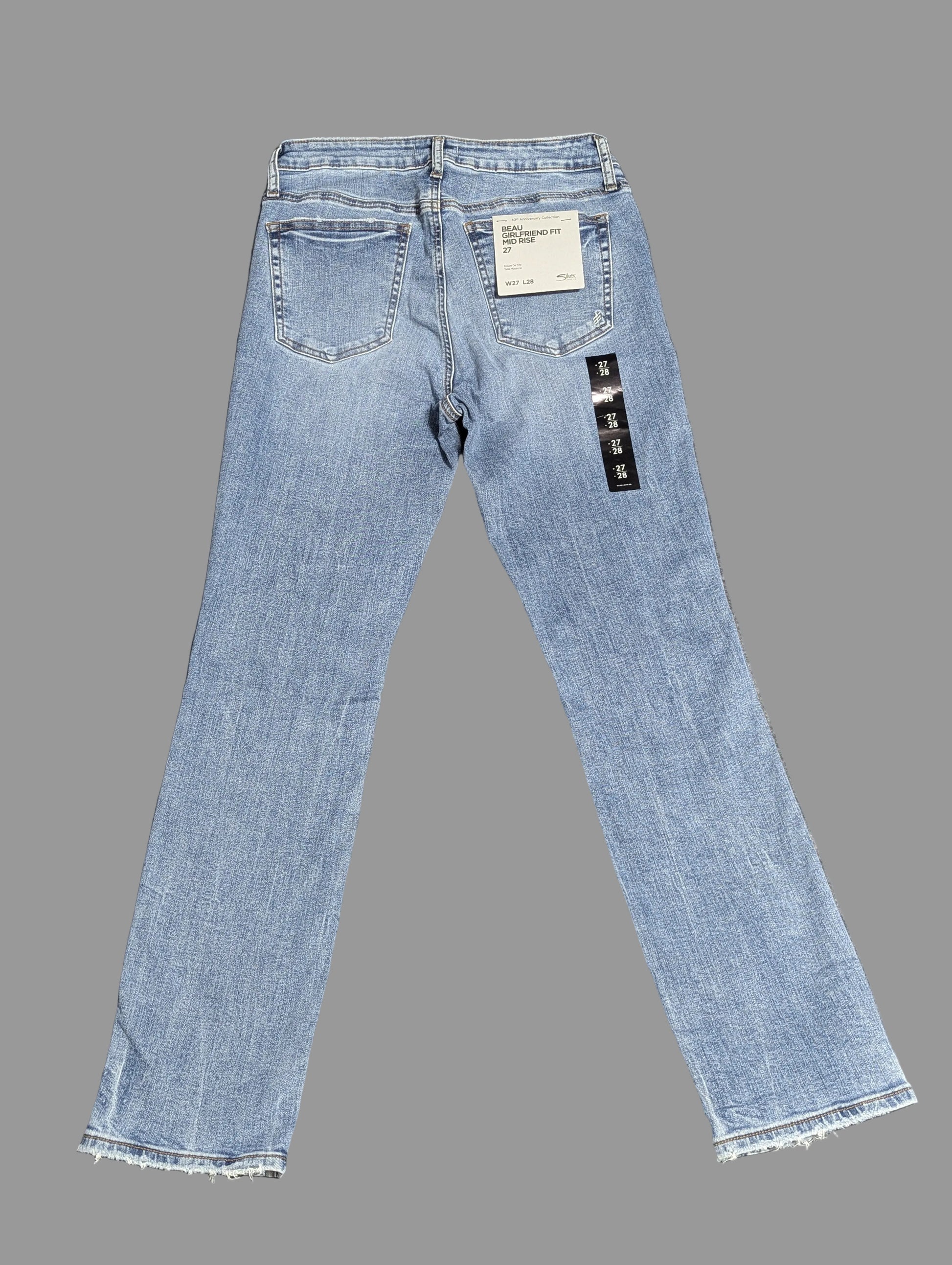 Front view of Silver Jeans "Beau" girlfriend fit mid-rise denim jeans in a medium wash with distressed details, highlighting a vintage thrift aesthetic.