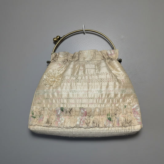 Vintage pastel brocade frame purse with a romantic scenic tapestry pattern and gold-tone metal kiss-lock handle.