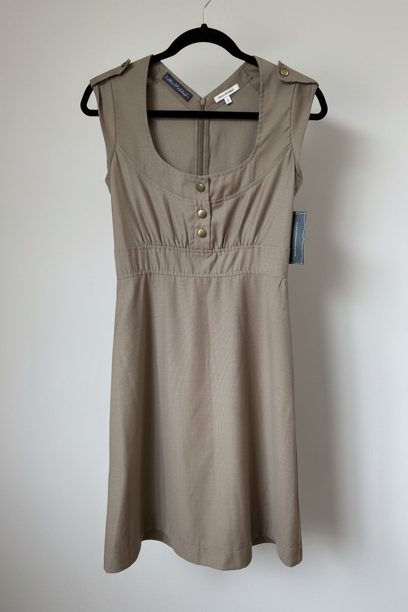 Front view of a khaki tan Allison Wonderland sleeveless midi dress with decorative front buttons and a structured scoop neckline hanging on a black hanger.