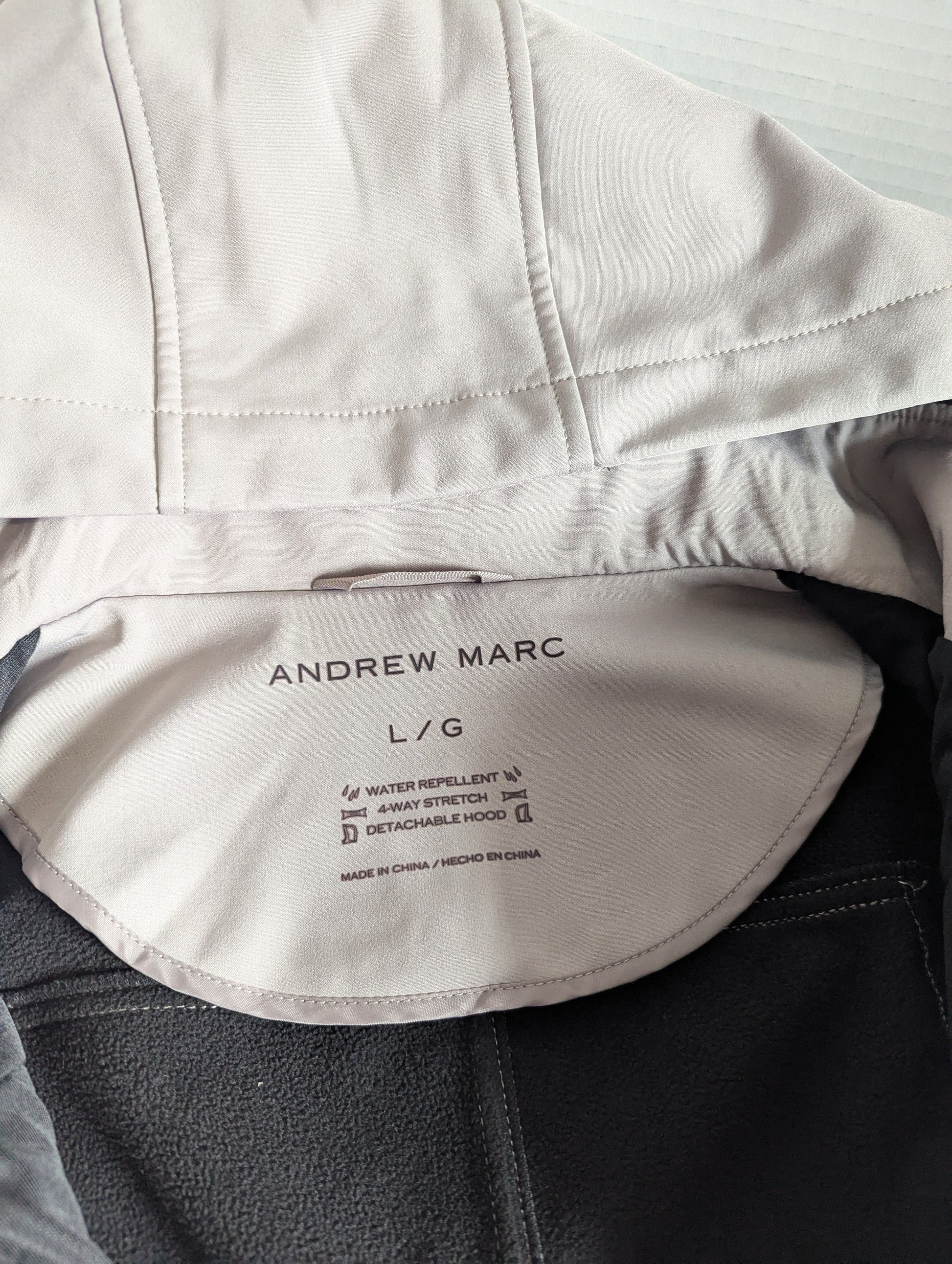 Close-up detail of the premium taupe 4-way stretch water-repellent polyester blend fabric on the Andrew Marc jacket.