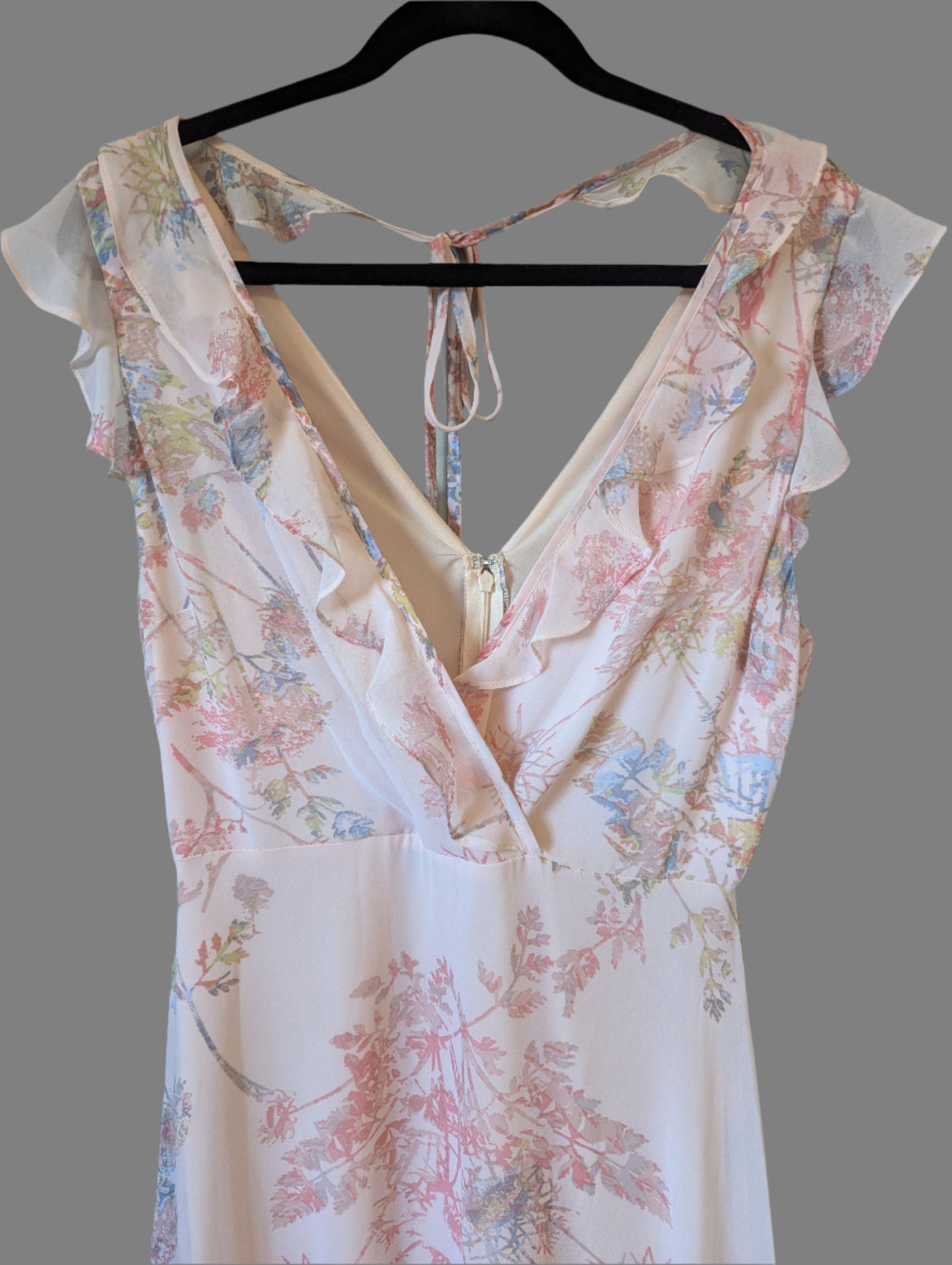 Close-up of the lightweight tiered ruffles on the pink floral BCBG dress, highlighting the premium fabric texture.