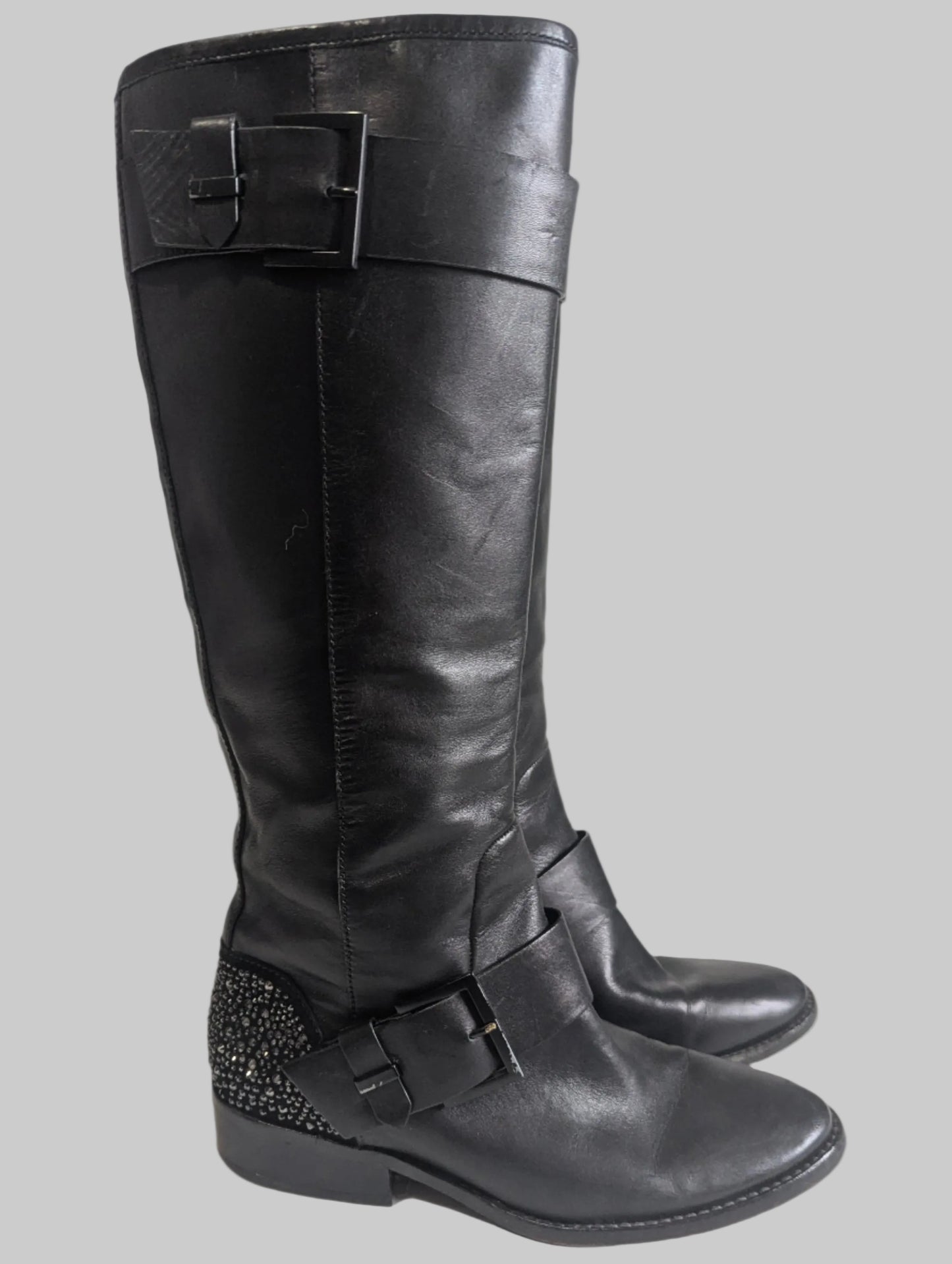 Side profile view of a black leather Brian Atwood Dita boot showcasing the structural design and high-end finish.