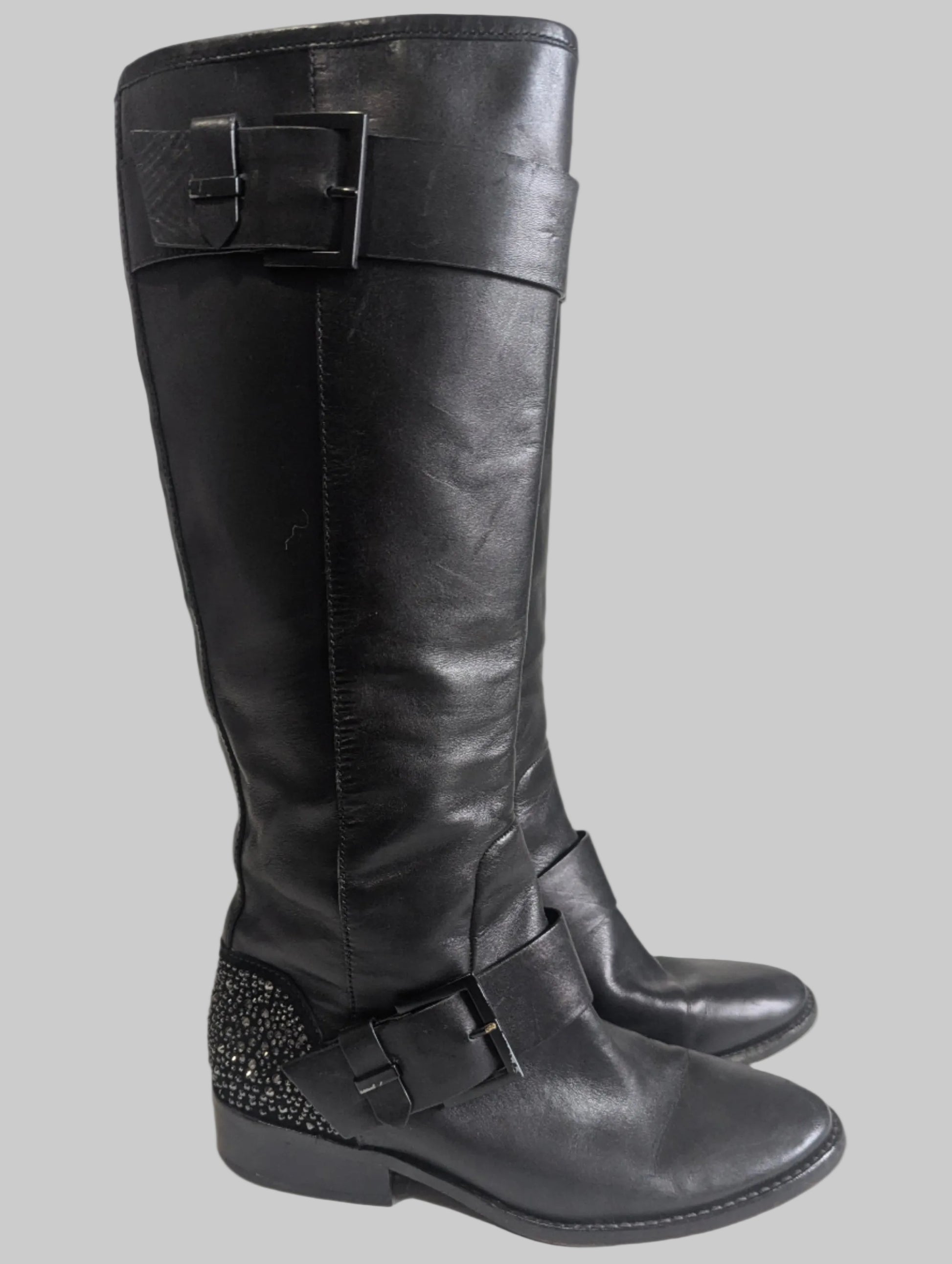 Side profile view of a black leather Brian Atwood Dita boot showcasing the structural design and high-end finish.