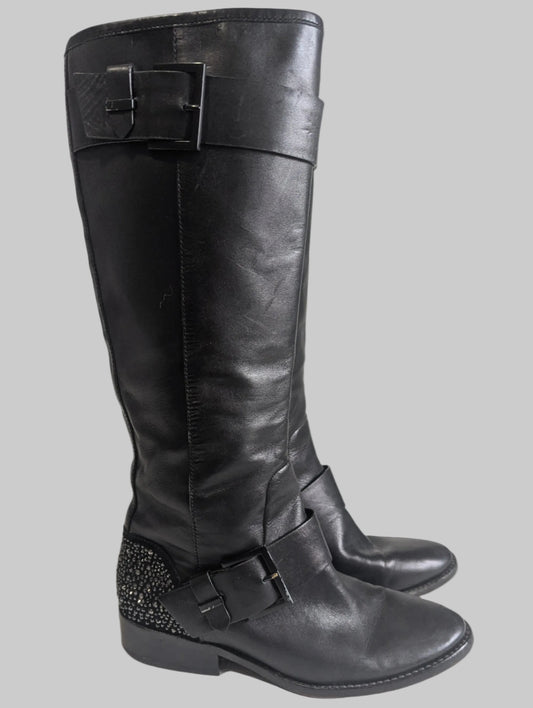 Side profile view of a black leather Brian Atwood Dita boot showcasing the structural design and high-end finish.