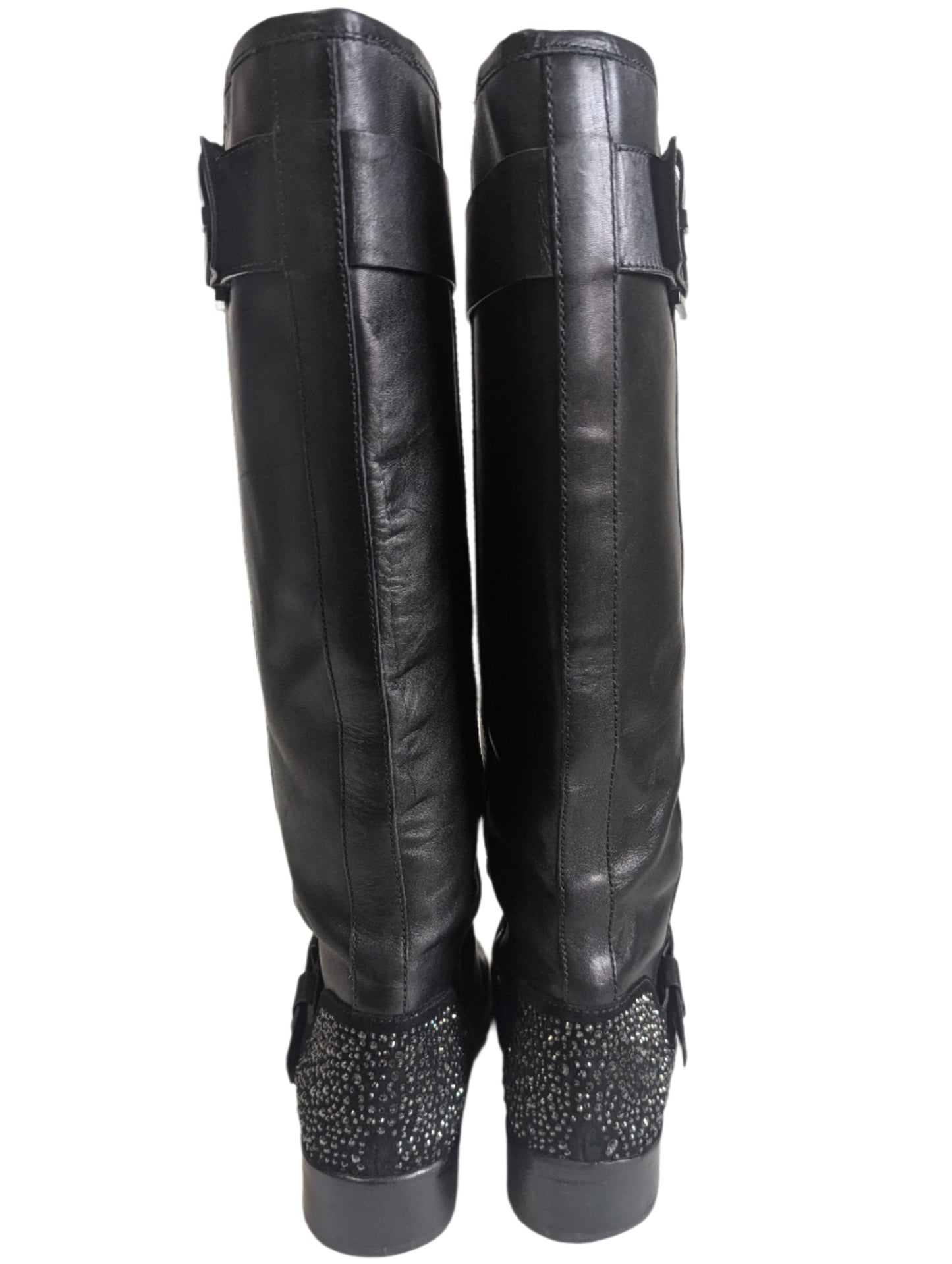 Detailed close-up of the signature geometric crystal diamond embellished high heel on the black Brian Atwood boot.