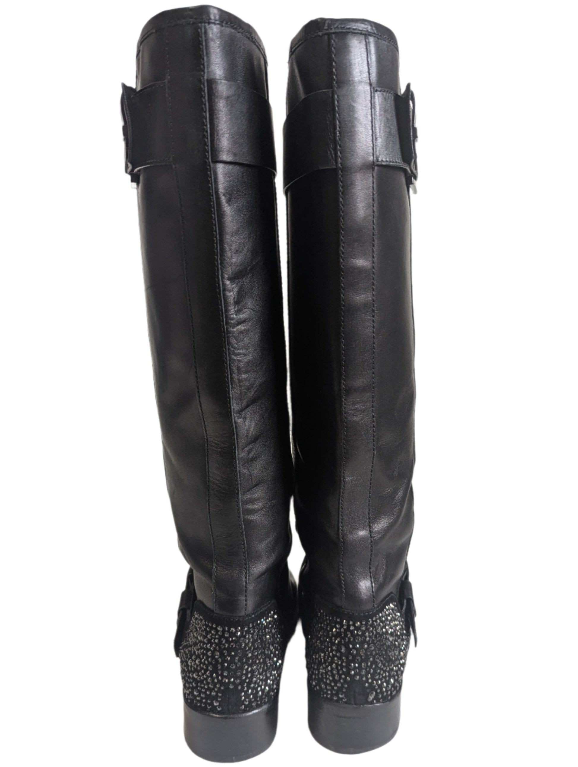Detailed close-up of the signature geometric crystal diamond embellished high heel on the black Brian Atwood boot.