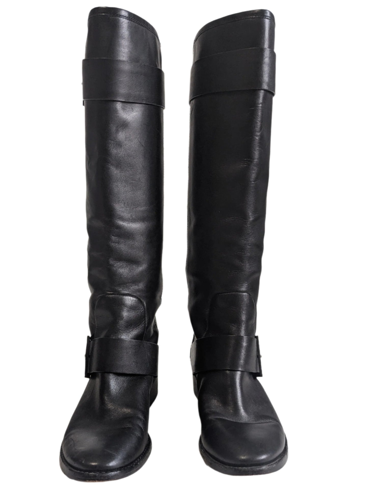 Front view of the pair of mid-calf Brian Atwood black leather boots standing upright.