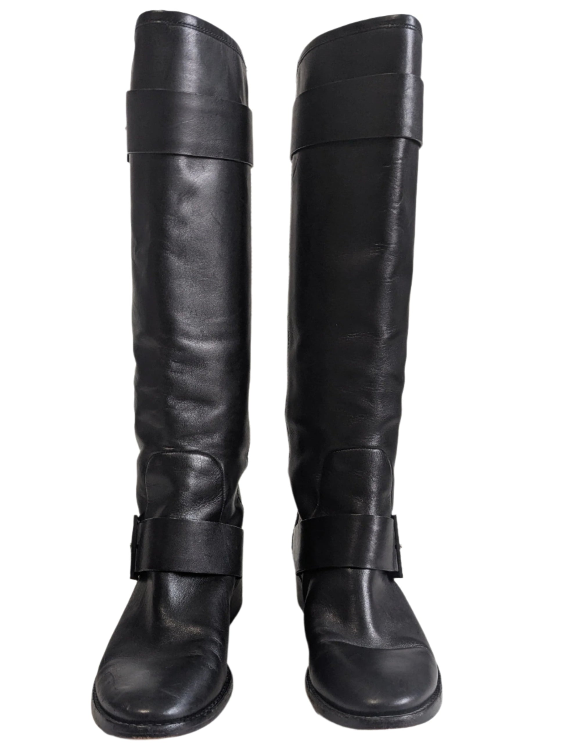 Front view of the pair of mid-calf Brian Atwood black leather boots standing upright.
