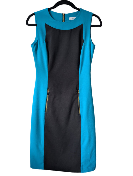 Front view of a sleeveless Calvin Klein color-block sheath dress in black and aqua blue hanging on a hanger