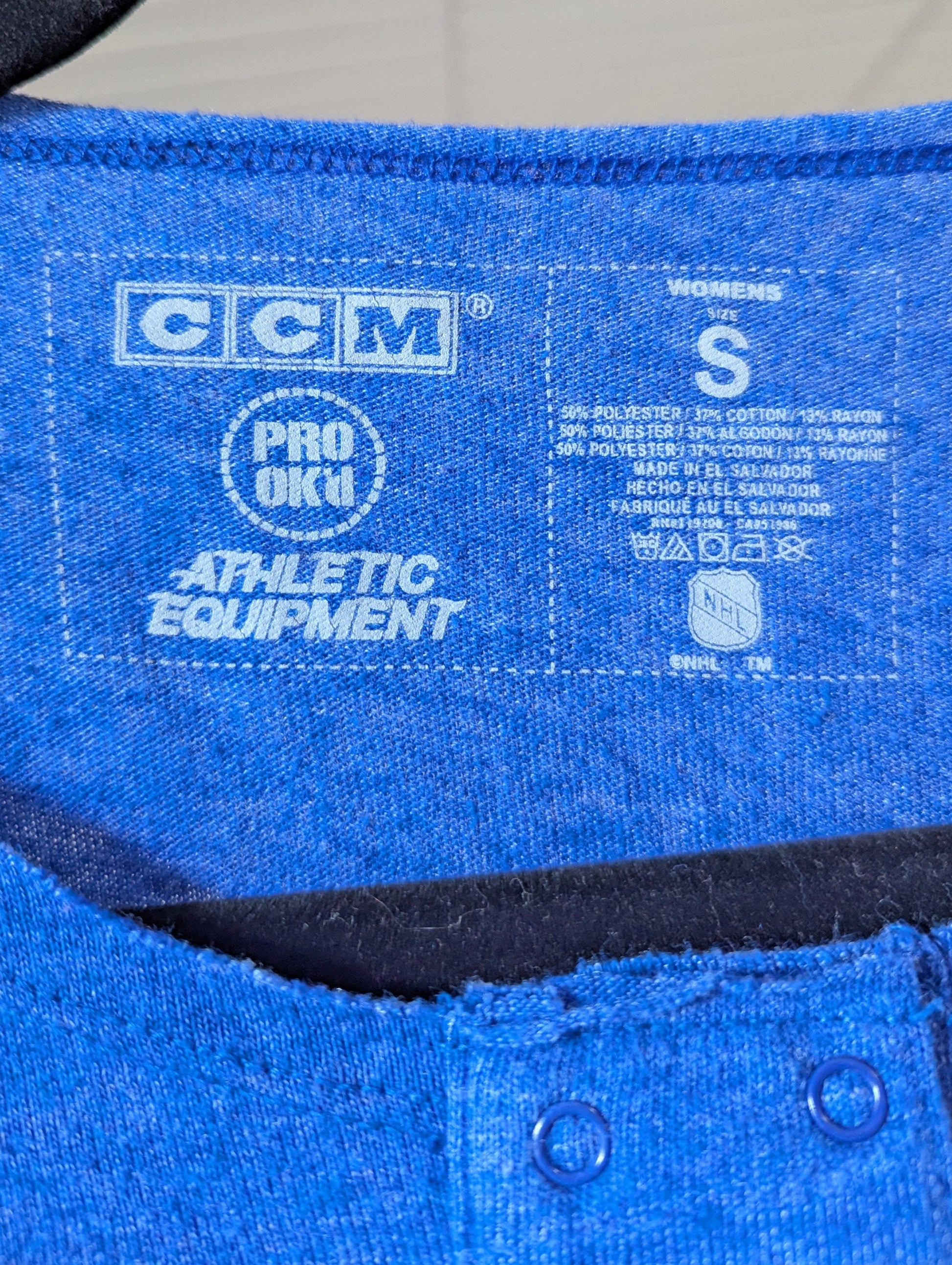 Close-up view of the lightweight blue poly-cotton blend fabric on the CCM shirt.
