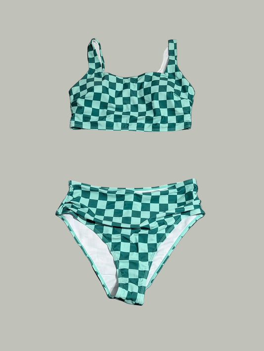 Front view of a curated thrift green and white checkered two-piece swimsuit with a cinched front detail on the bikini top, laid fla