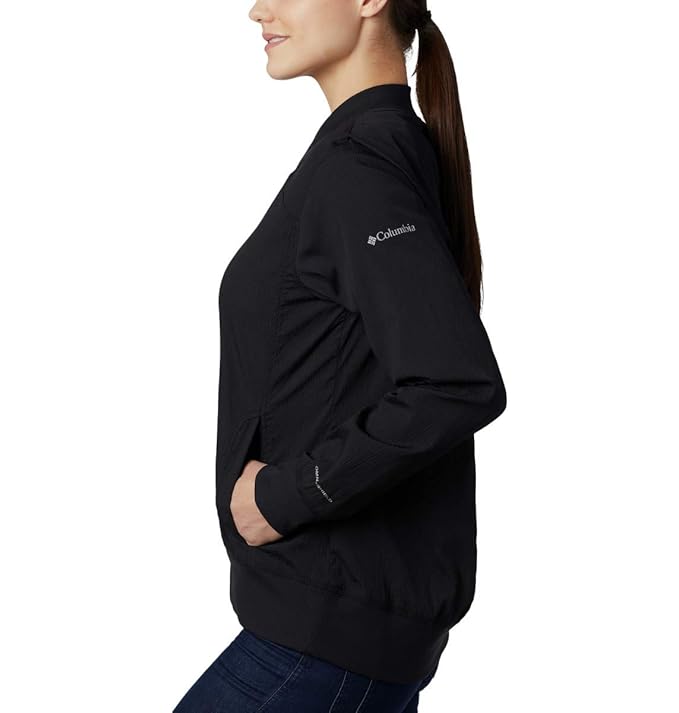 Side angle view of the black Columbia long bomber jacket highlighting the athletic silhouette.
