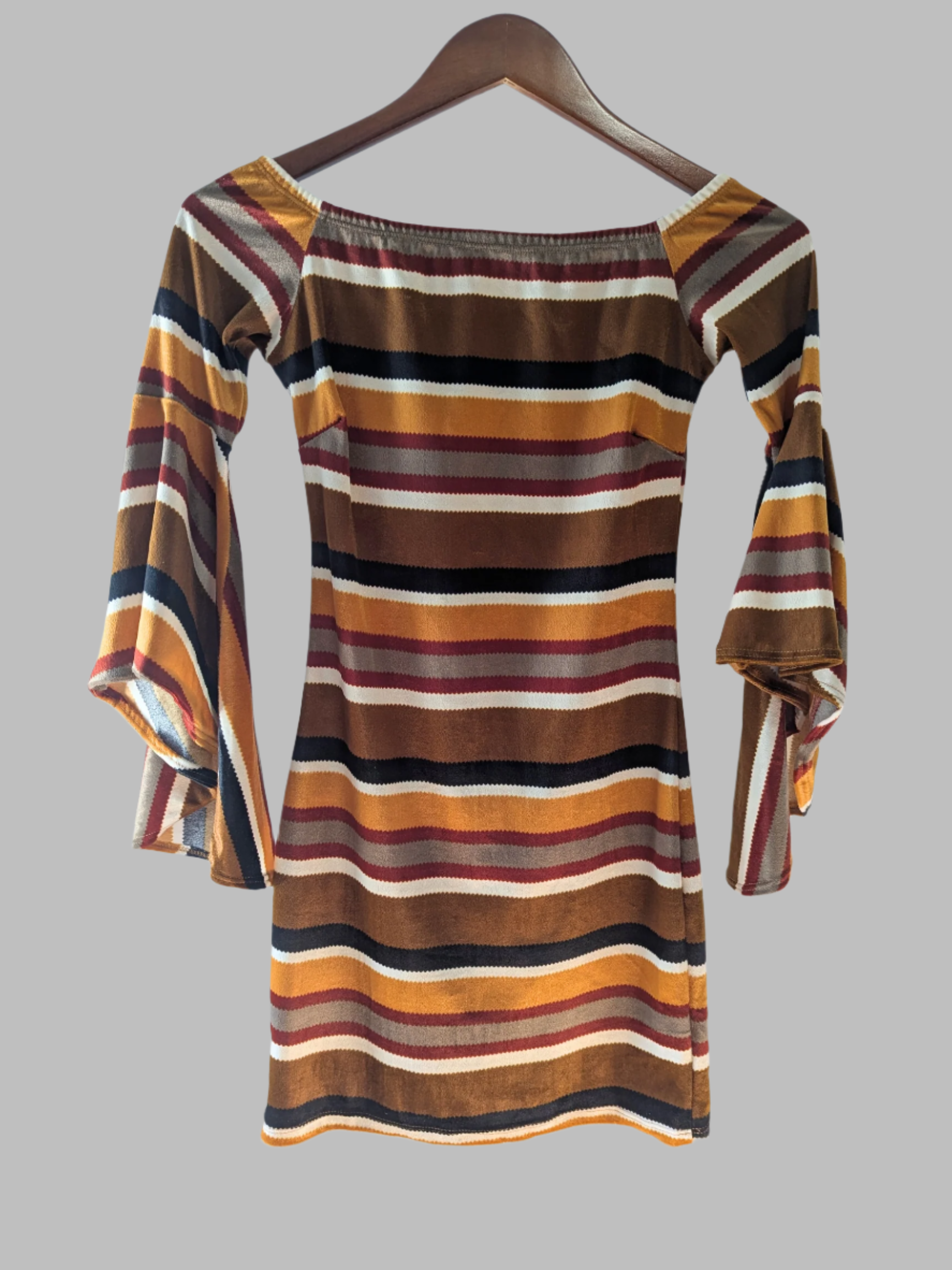 Back view of the striped Diosa mini dress showing the continuous pattern design and pencil style fit.