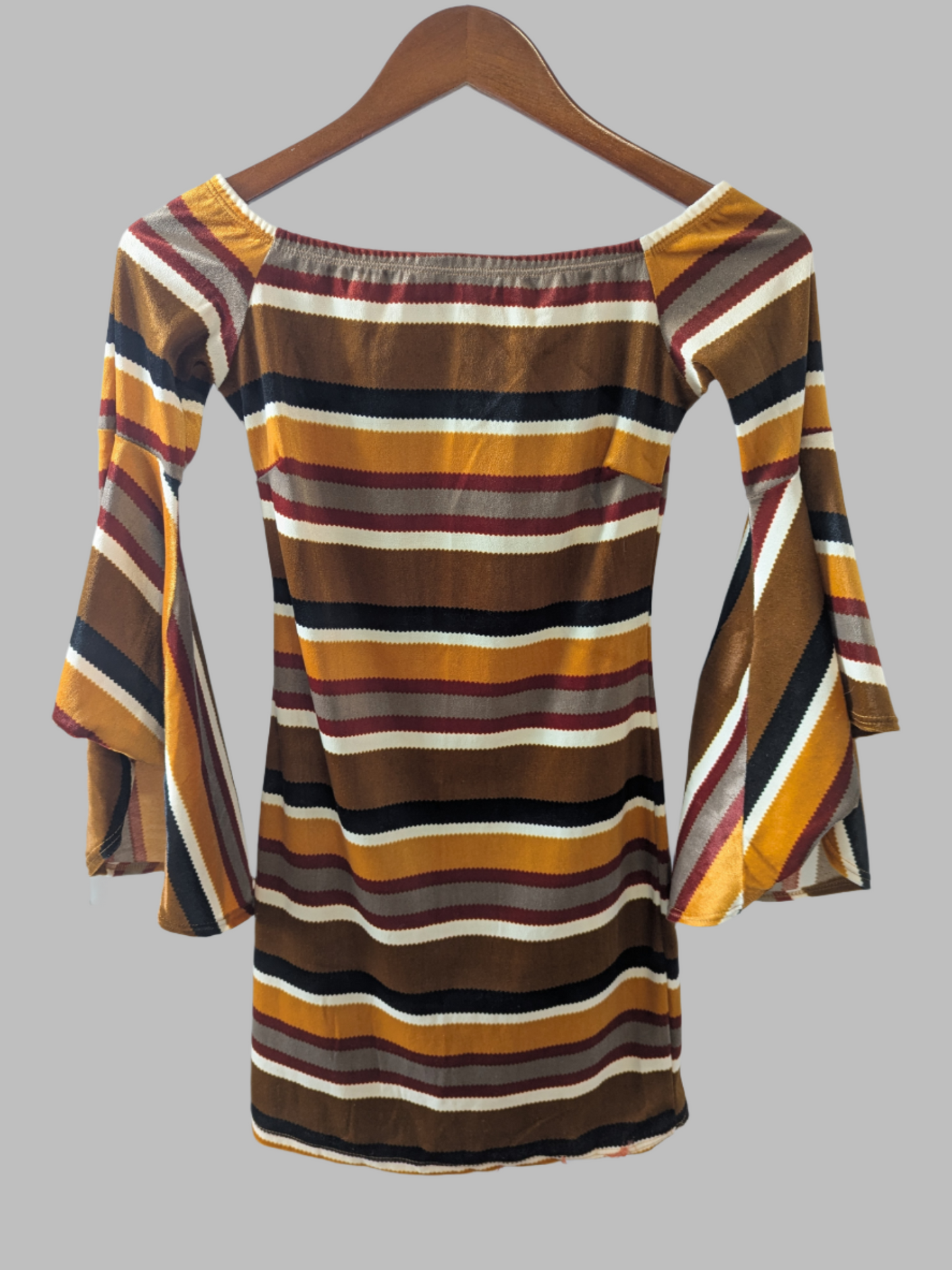 Front view of a multi-colored striped Diosa off-shoulder mini dress with bell sleeves hanging on a wood hanger.