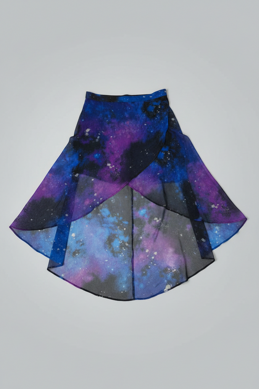 Front view of a multicolored cosmic galaxy print high-low skirt with a sheer overlay hanging on a white studio background.