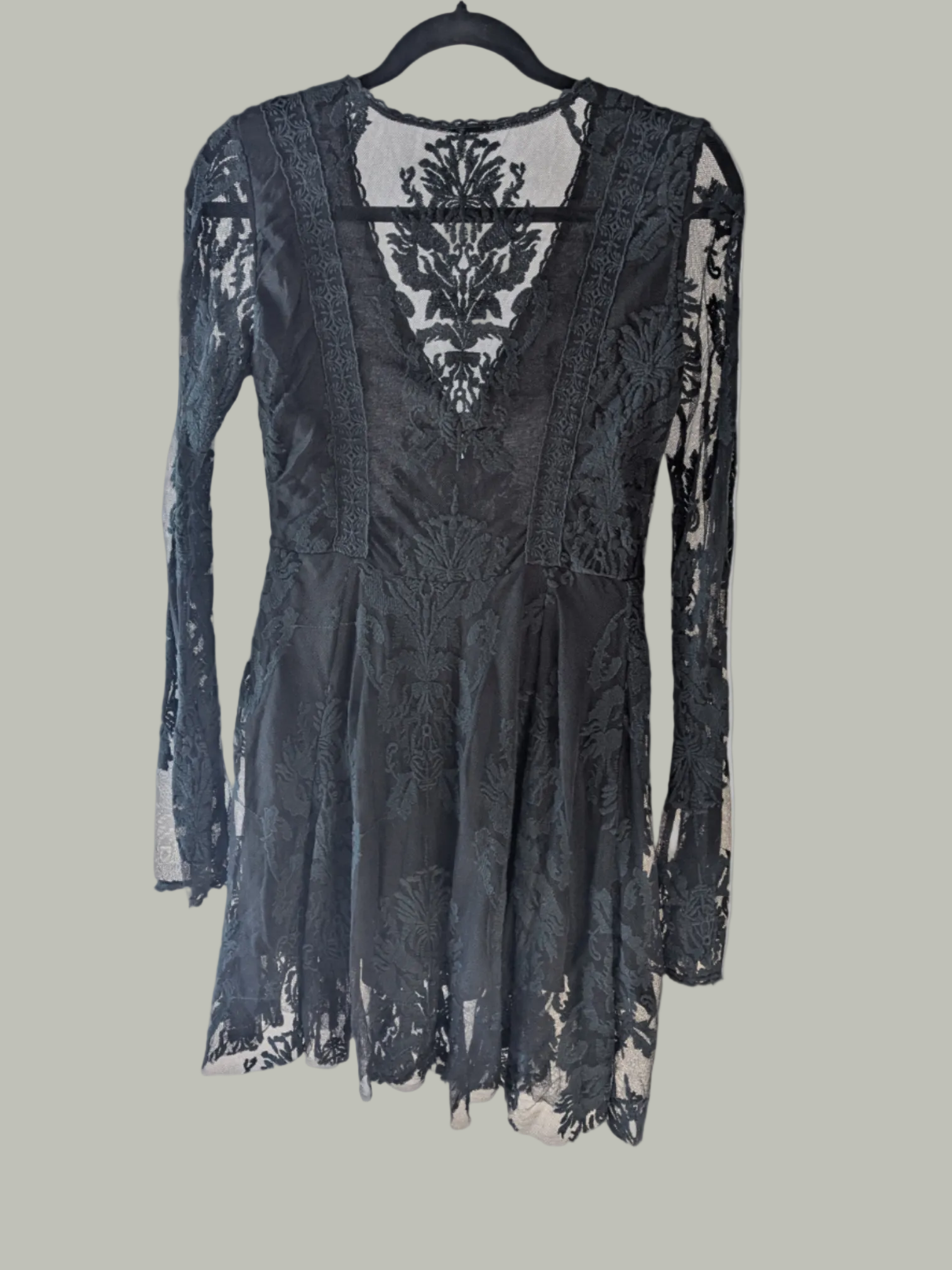 Back view of the black Free People Reign Over Me lace mini dress highlighting the fit-and-flare silhouette.