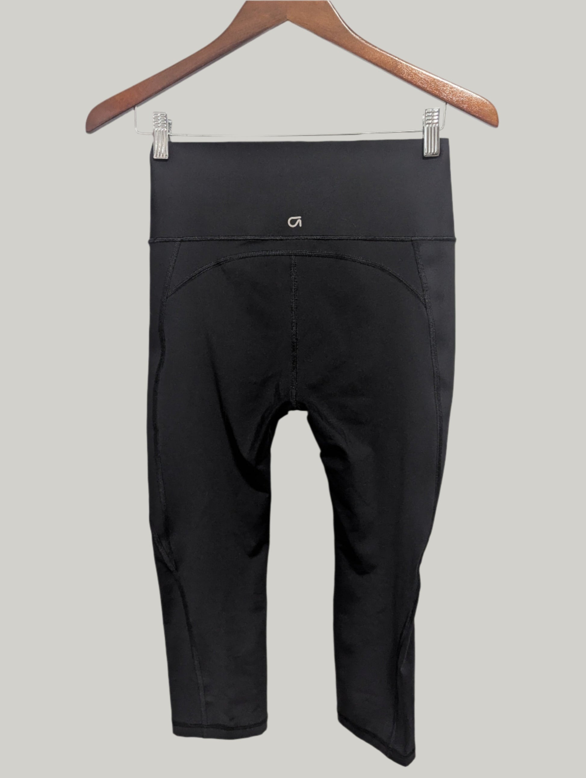 Back view of the black Gap Fit compression cropped leggings showing the clean athletic seams