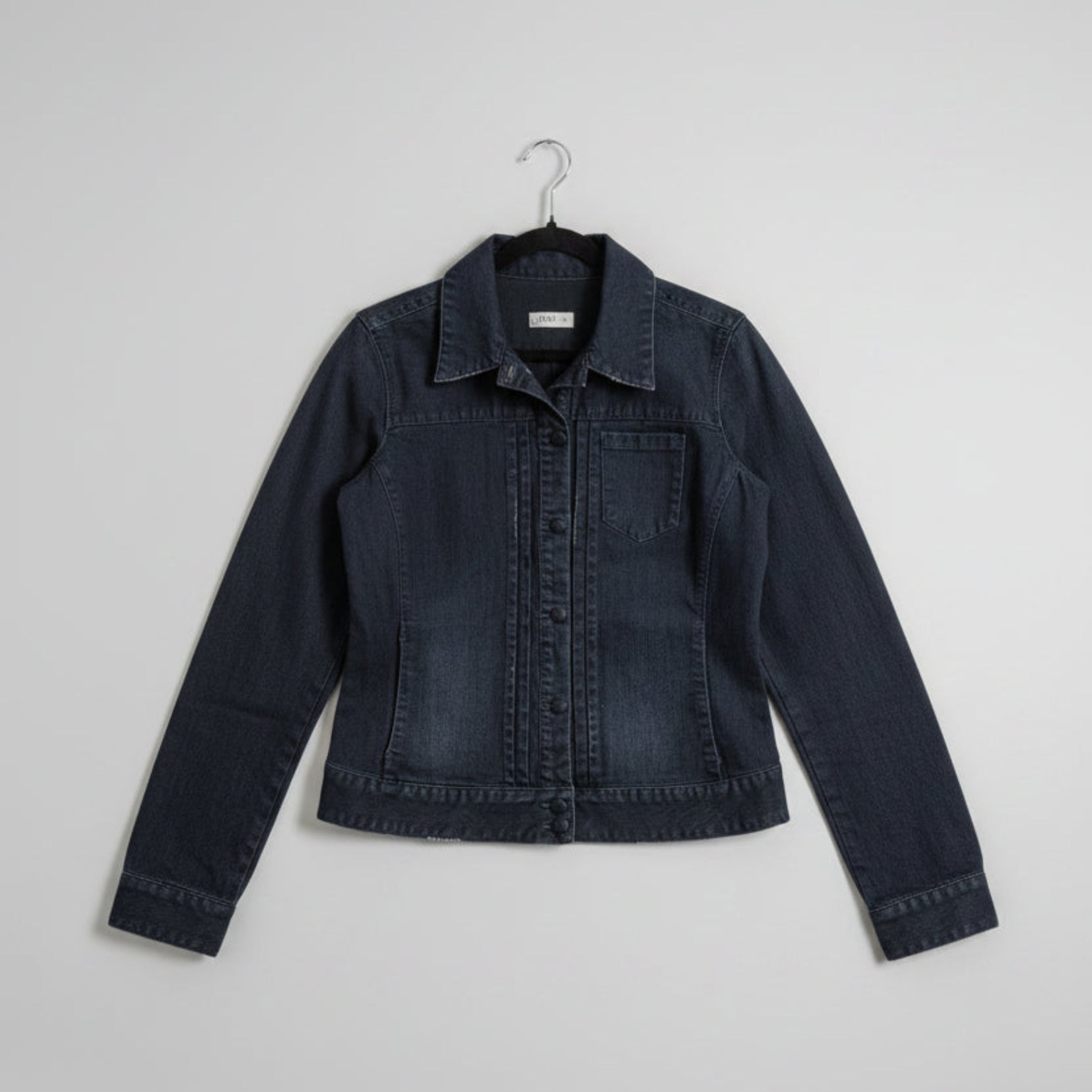 Front view of a dark wash Gap deep indigo distressed denim trucker jacket with button-up closure and front pockets.