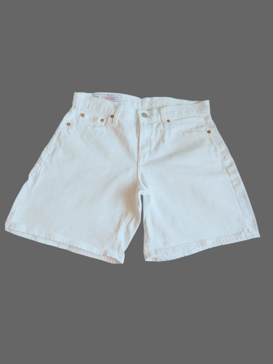 Front view of white denim Gap girlfriend mid-rise shorts on a dark gray background