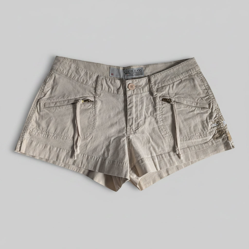 Front view of khaki tan Guess mini shorts featuring an embroidered waistband design and front zipper pockets.