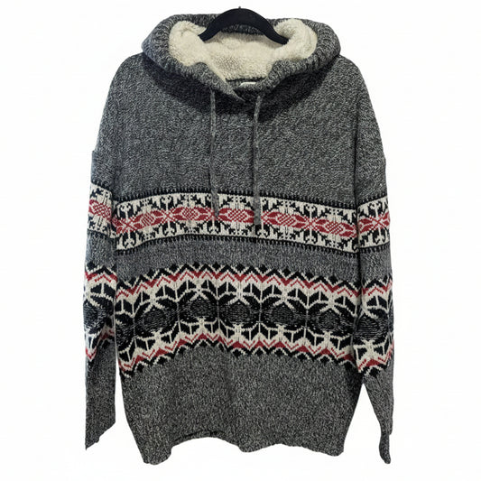 Close-up detail of the cozy acrylic-polyester blend knit texture and intricate snowflake pattern on the Kismet winter sweater.
