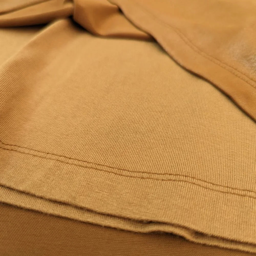 Extreme close-up of the pleated metallic bronze fabric on the Lady Dutch vintage dress, showing the material quality.