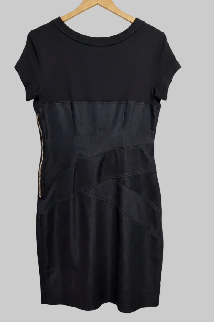 Full length back view of the dark denim and black short sleeve pencil dress.