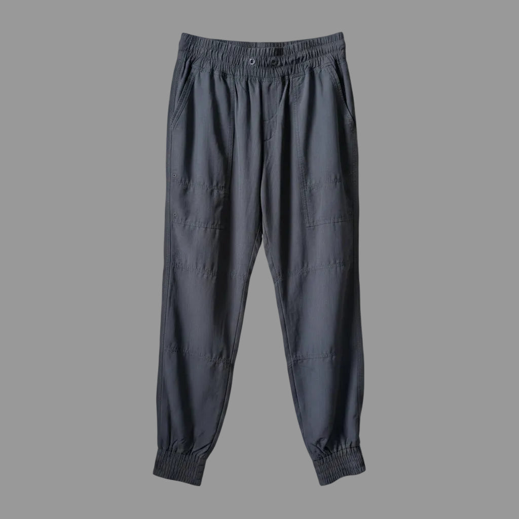 Front view of women's black MEC trek hiking pants with cinched ankles hanging on a hanger.