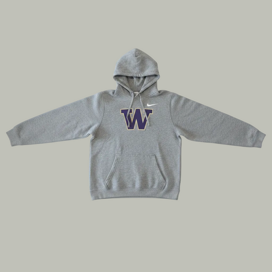 Front view of a grey Nike Washington Huskies pullover hoodie featuring a purple varsity letter W lay flat