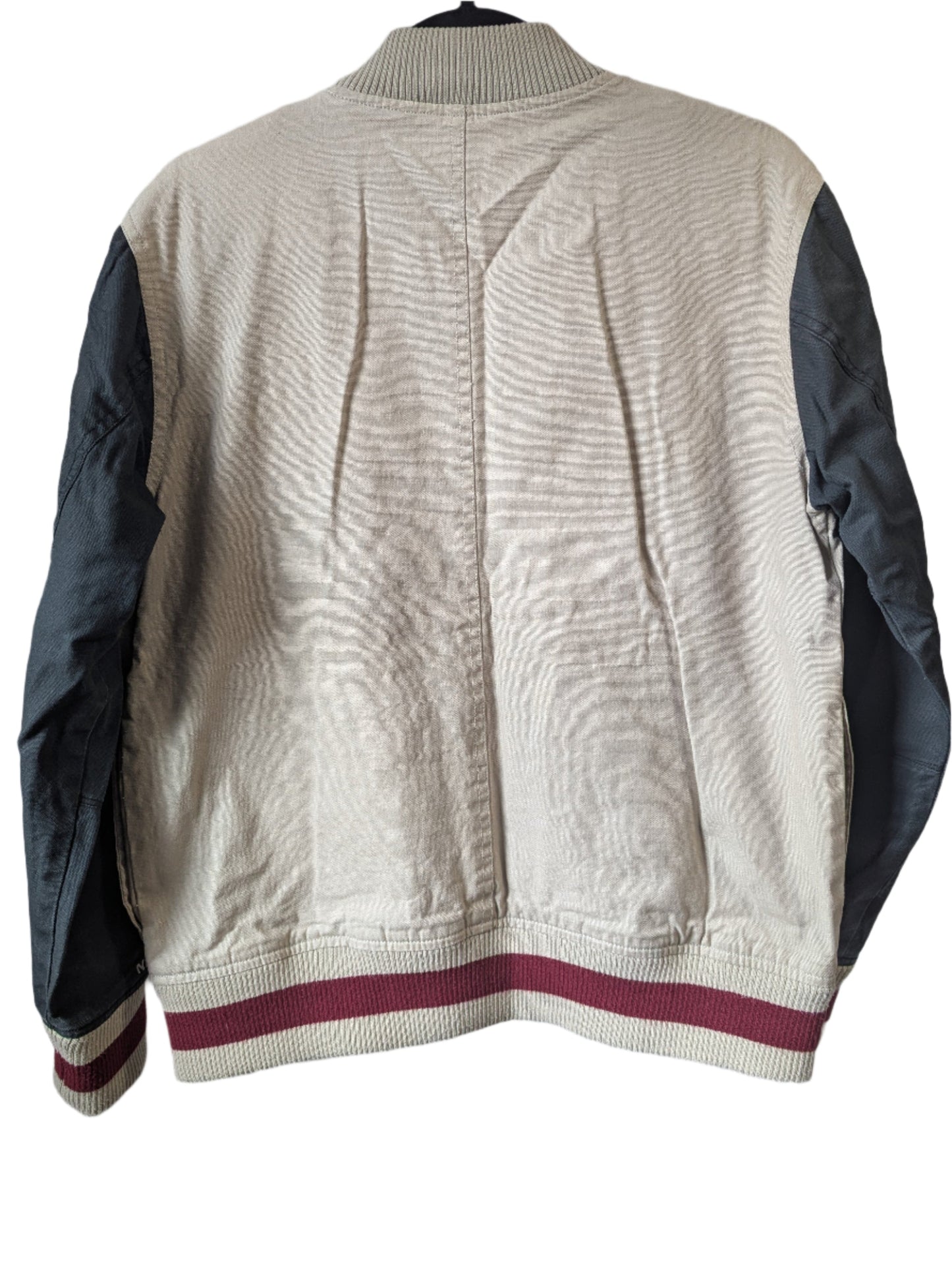 Back view of the vintage Nixon University varsity jacket highlighting the clean charcoal grey paneling and casual streetwear silhouette.