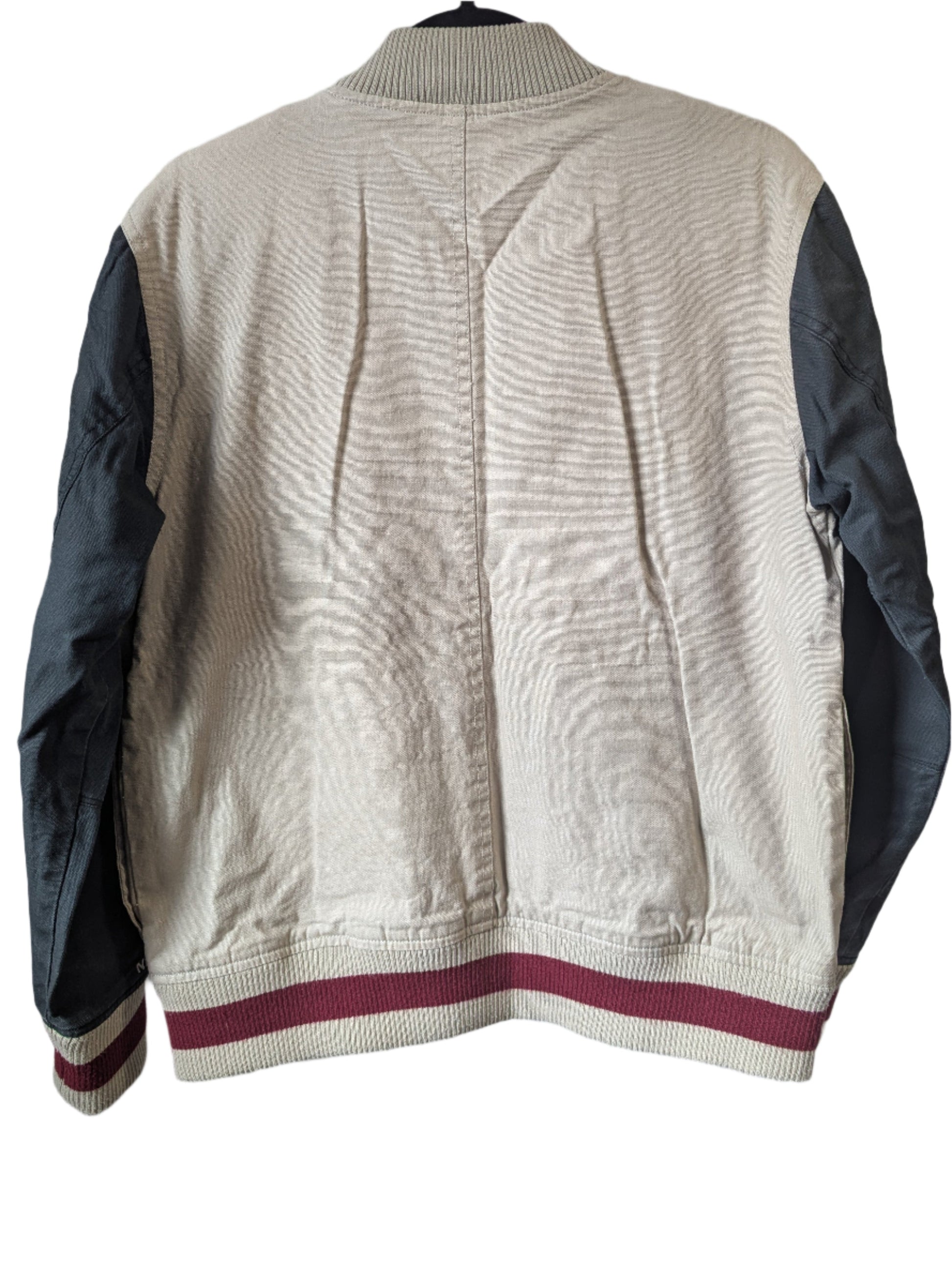 Back view of the vintage Nixon University varsity jacket highlighting the clean charcoal grey paneling and casual streetwear silhouette.