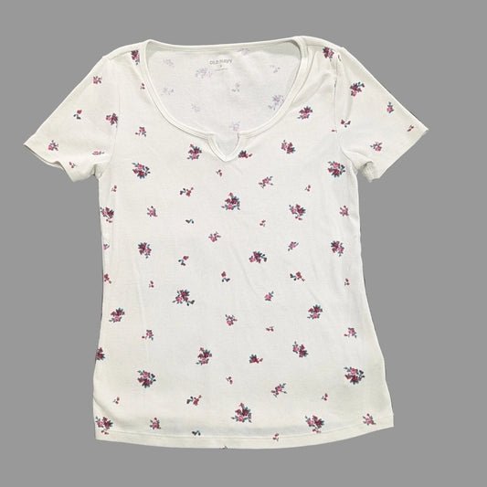 Front full-length view of a white Old Navy ribbed knit t-shirt with a dainty multi-colored floral print, channeling a cottagecore aesthetic lay flat