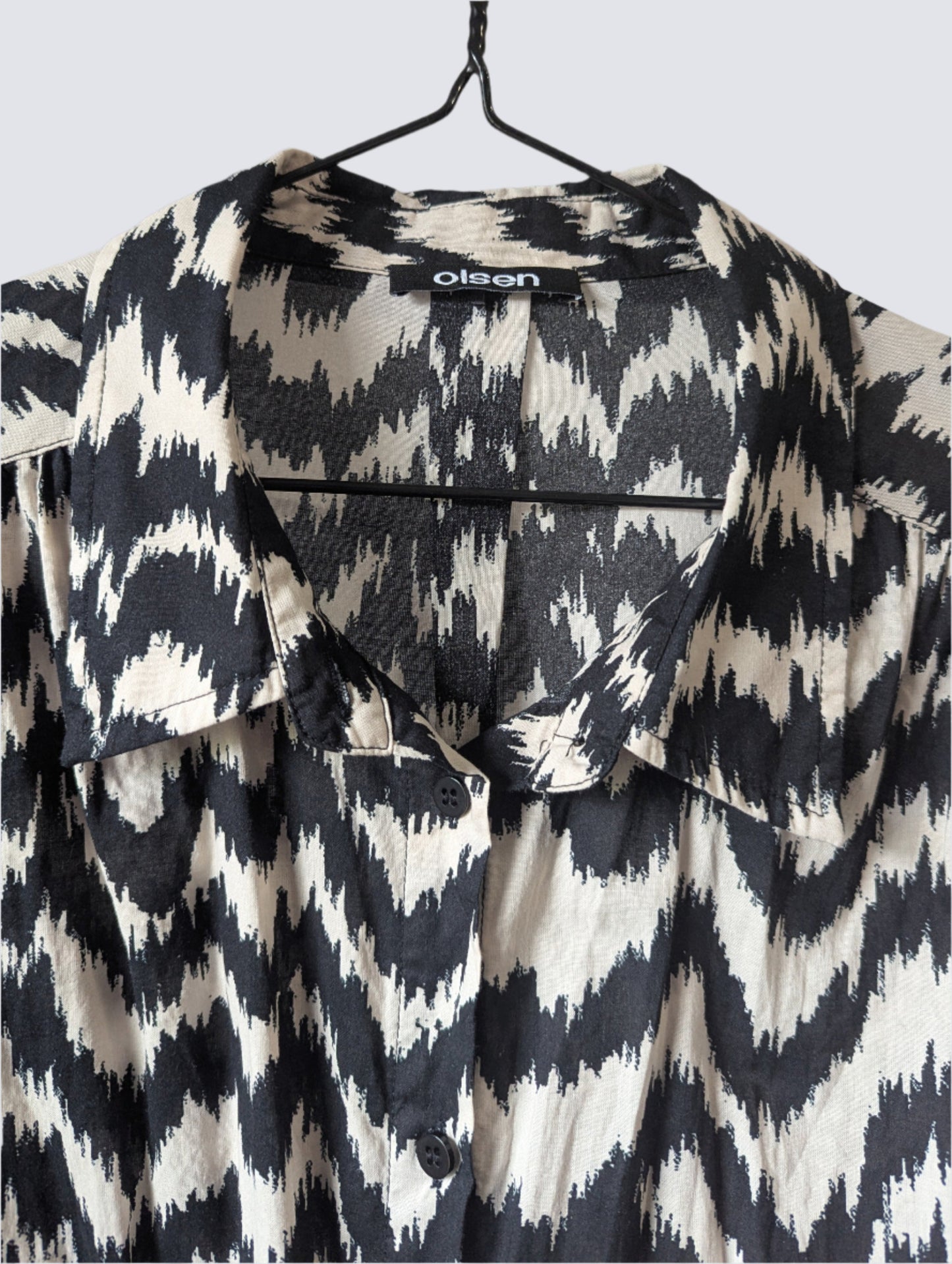 Detailed close-up view of the bold black and off-white zebra pattern on the breathable 100% cotton fabric of the Olsen dress.
