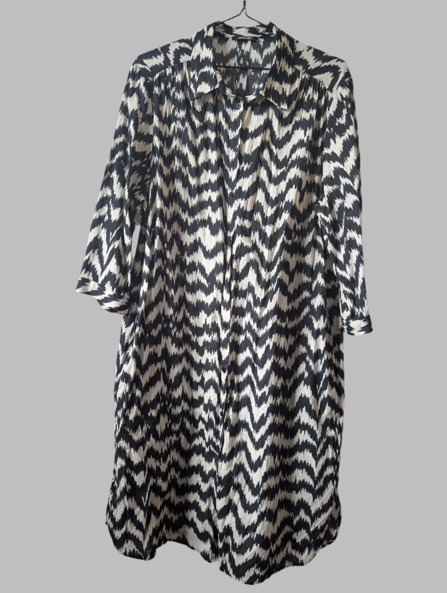 Front view of a black and off-white Olsen zebra print button-down midi shirt dress hanging on a hanger