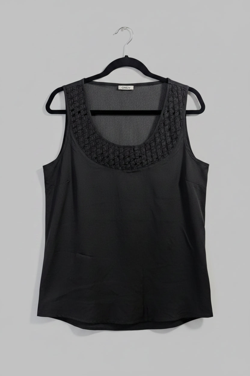 Front view of a black sleeveless ONLY tank top featuring an intricate geometric laser cutout design across the chest.