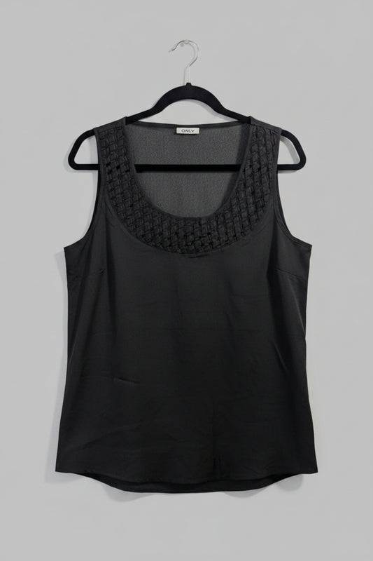 Front view of a black sleeveless ONLY tank top featuring an intricate geometric laser cutout design across the chest.