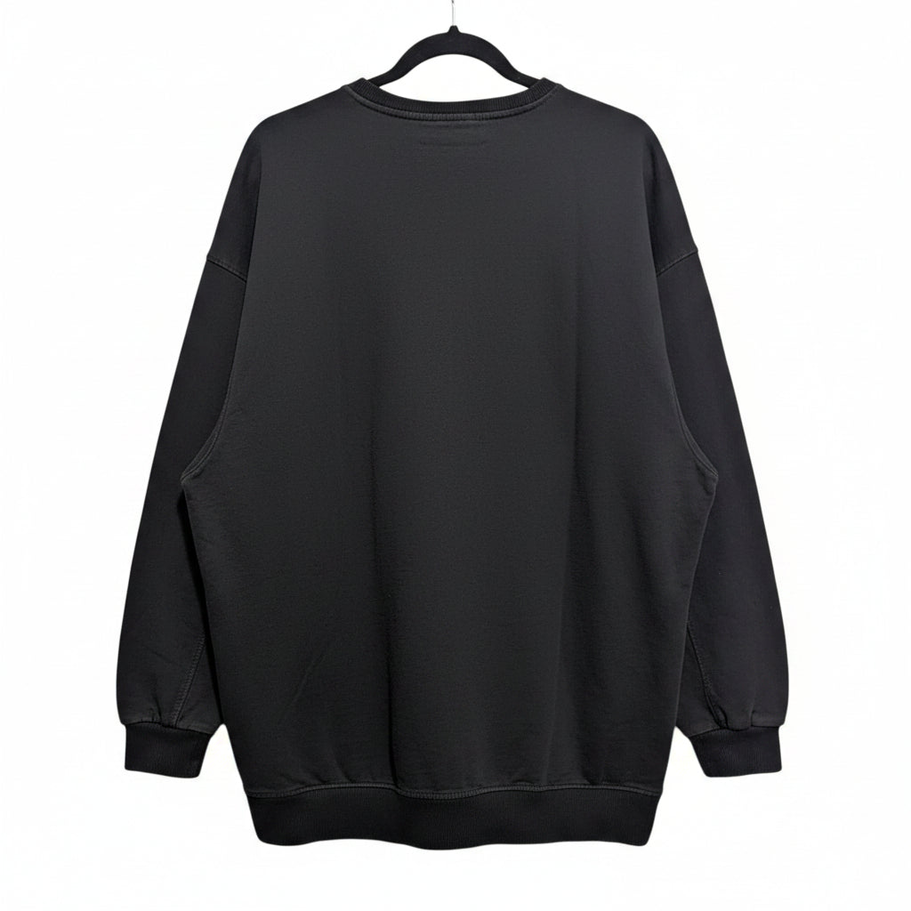 Back view of the relaxed, longline faded black crew neck sweatshirt on a hanger showing the cozy fit