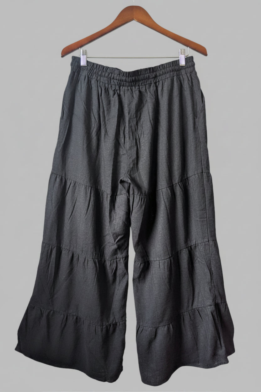 Back view of the relaxed fit black Papillon wide leg trousers, showcasing the comfortable, breezy silhouette.