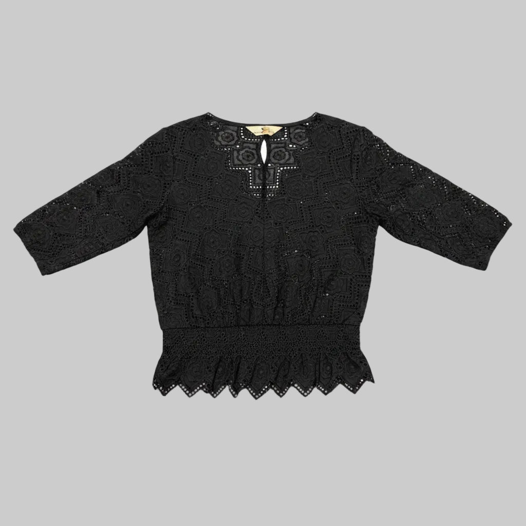 Front view of a black Qian Zijin 3/4 sleeve peplum top with rose lace embellishments laying flat