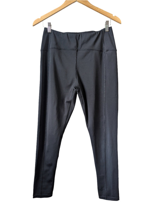 Front view of black high-waisted Queenie Ke yoga pants hanging on a wooden hanger.