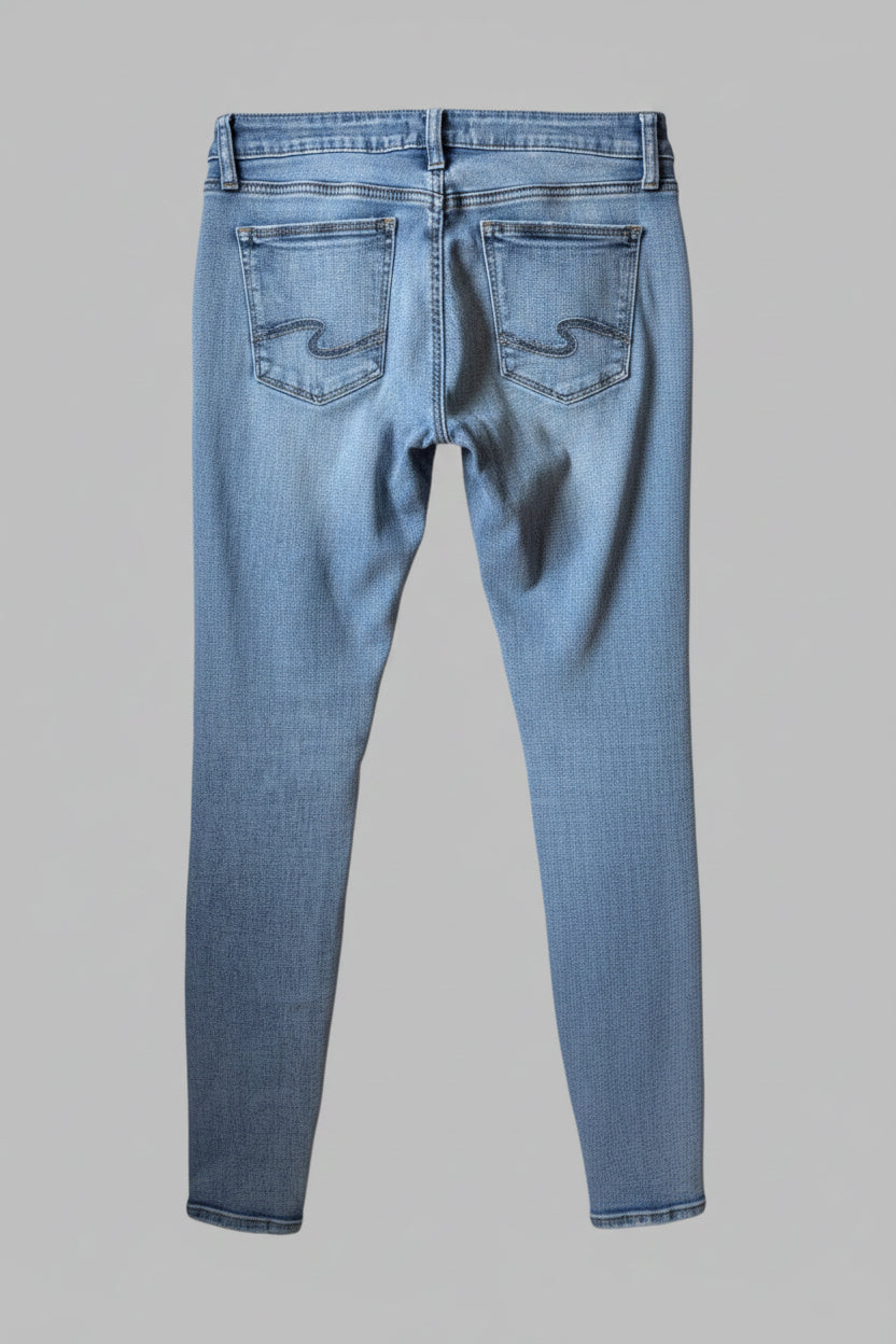 Back view of women's Silver Jeans Suki skinny light wash distressed denim pants 